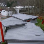 Zink Doppelstehfalztechnik, Alu-Wellfassade und Zink Steckfalzpaneele